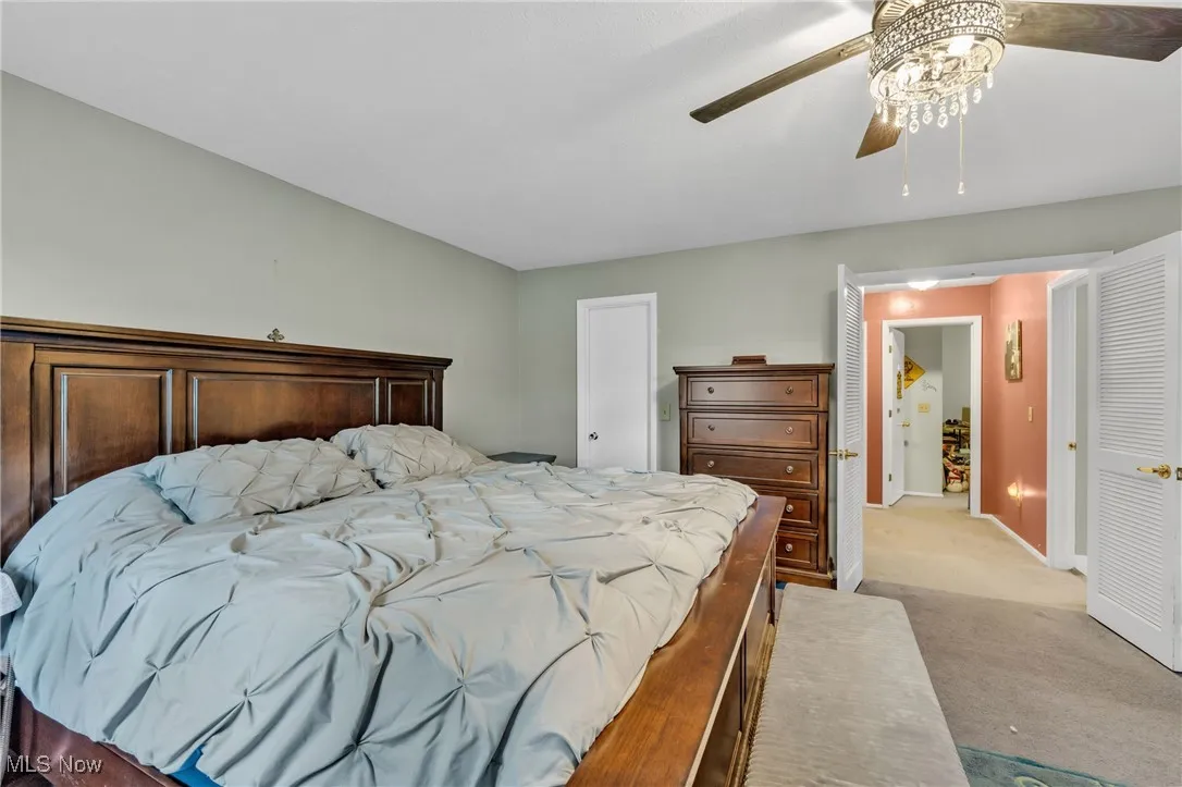 Primary Bedroom featuring a closet, carpet flooring, and a ceiling fan