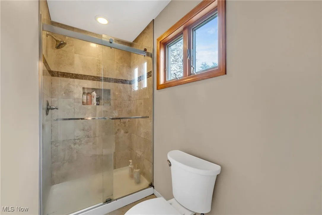 Primary Bathroom featuring a shower with glass doors