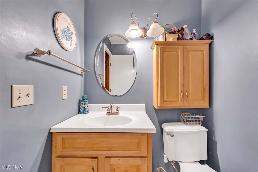 1/2 Bathroom with vanity and toilet