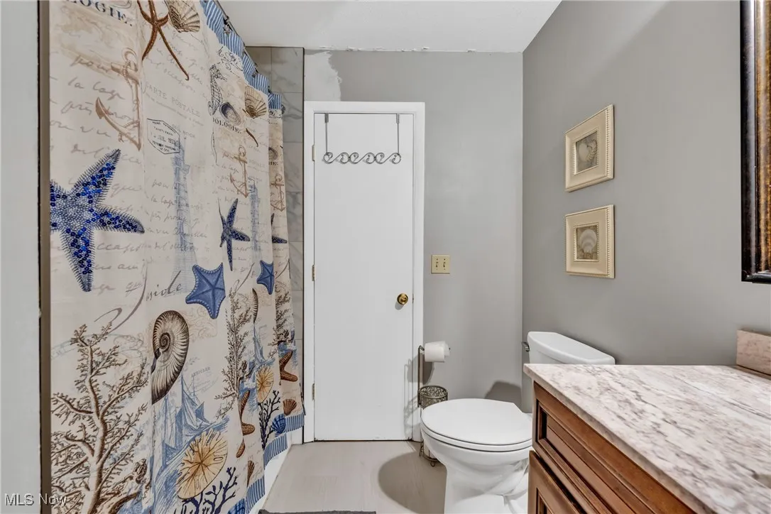 Bathroom featuring vanity and a shower with shower curtain