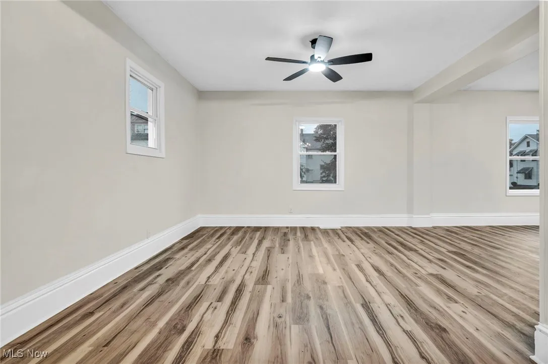 Unfurnished room with wood finished floors and ceiling fan