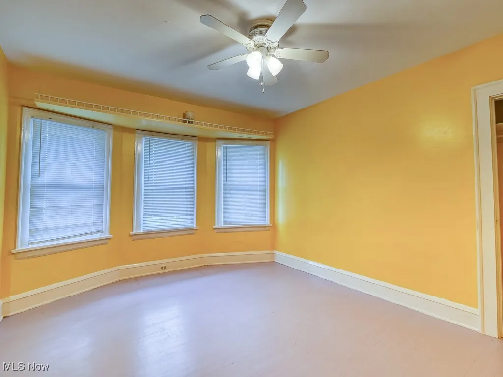 Unfurnished room with wood finished floors and ceiling fan