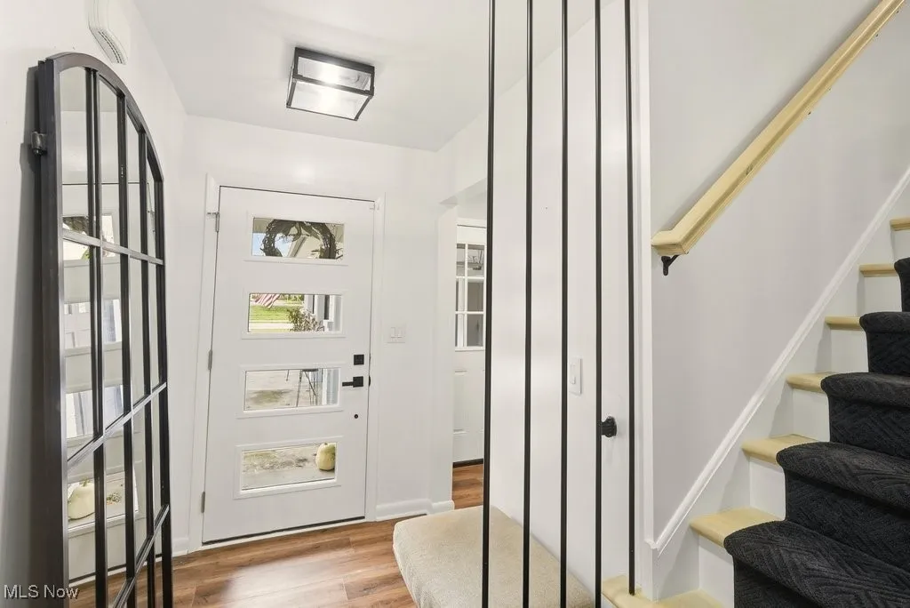 Entryway with stairway and light wood finished floors