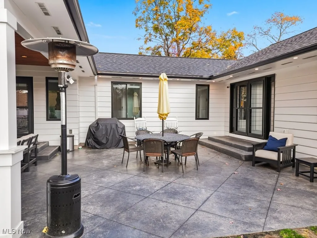 View of patio with grilling area and outdoor dining area