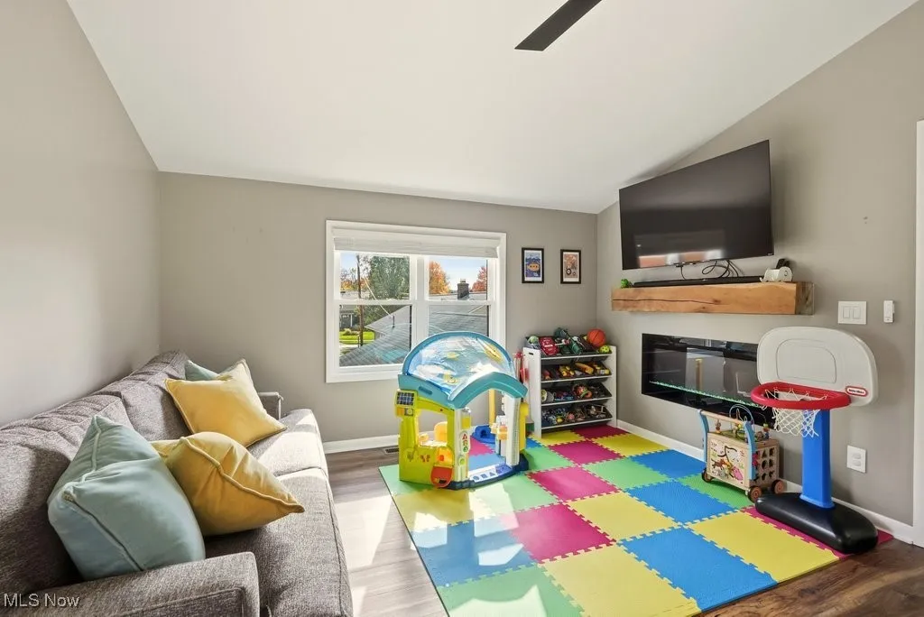 Game room featuring vaulted ceiling, wood finished floors, and ceiling fan