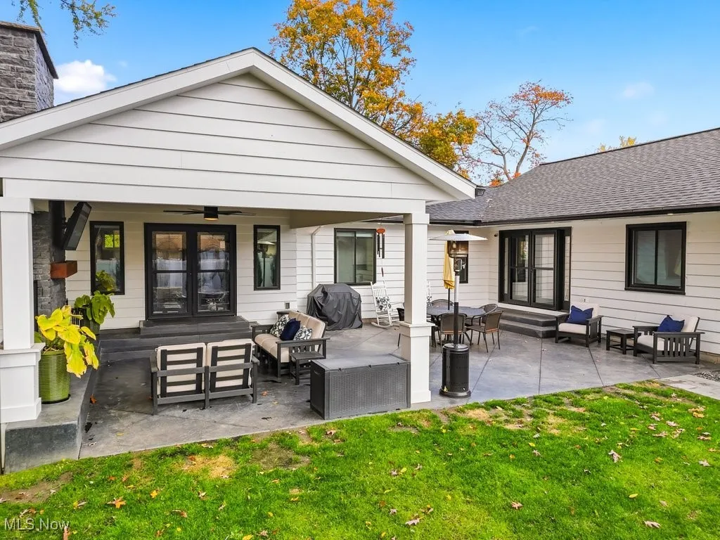 Rear view of house featuring an outdoor living space, a patio area, a ceiling fan, a yard, and roof with shingles