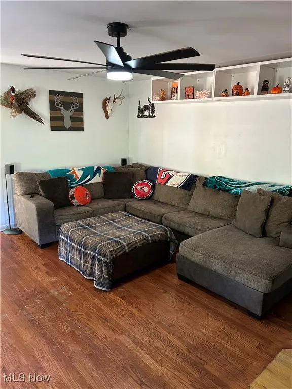Living room featuring wood finished floors and a ceiling fan