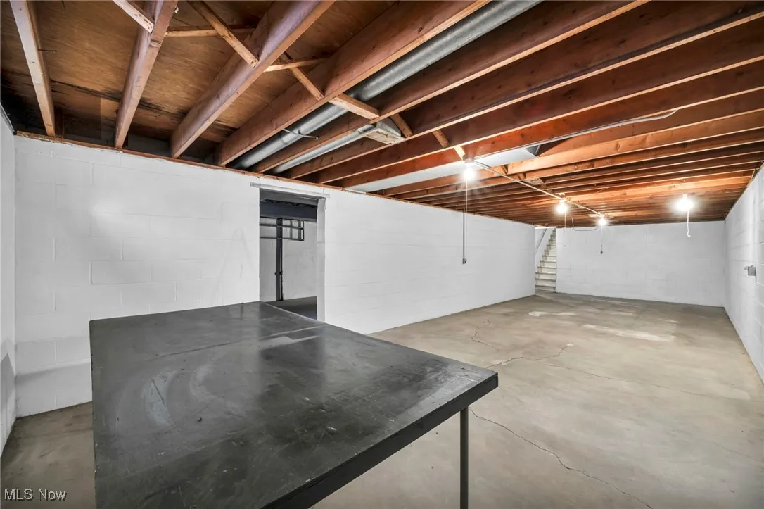 Unfinished basement featuring stairway