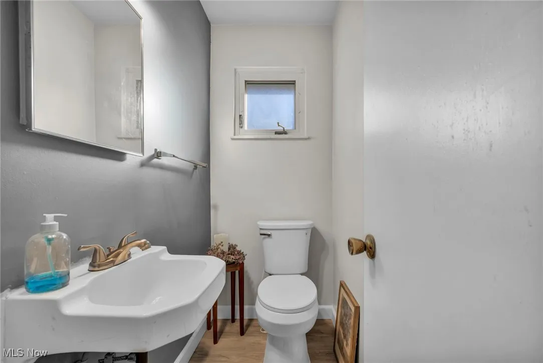 Bathroom with wood finished floors and toilet