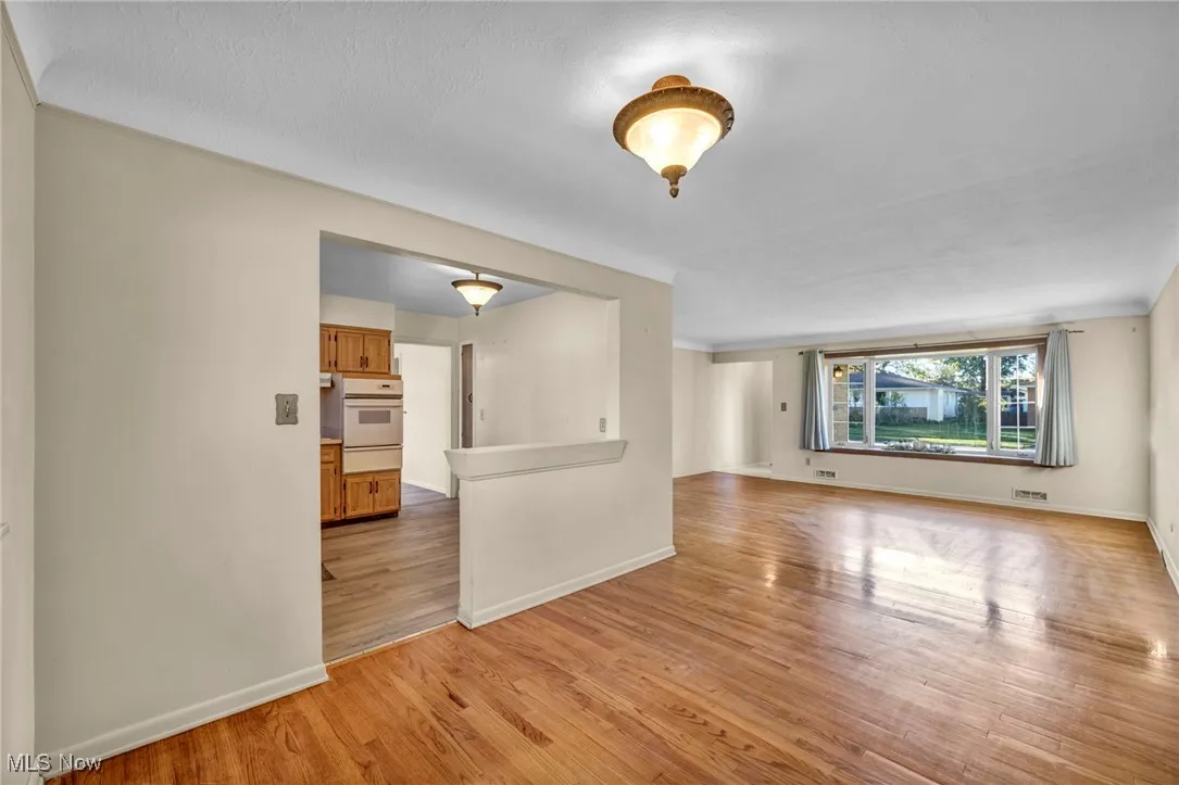 Unfurnished room featuring light wood-type flooring and baseboards