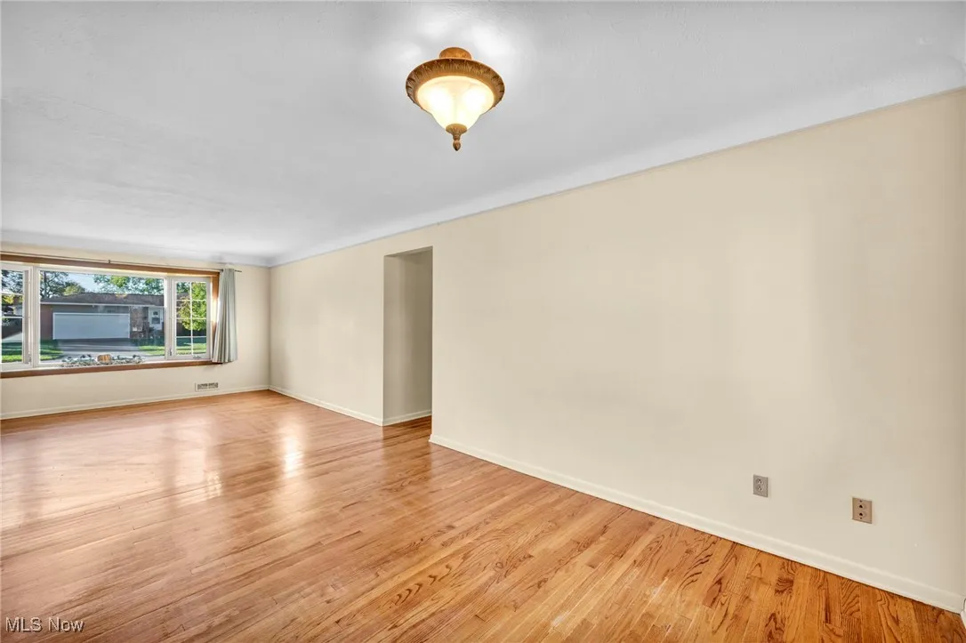 Spare room featuring light wood finished floors and baseboards