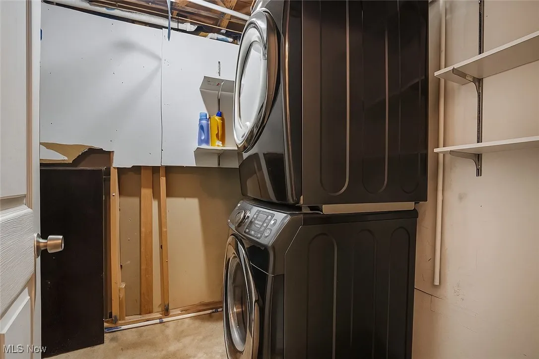 Laundry area with stacked washing machine and dryer