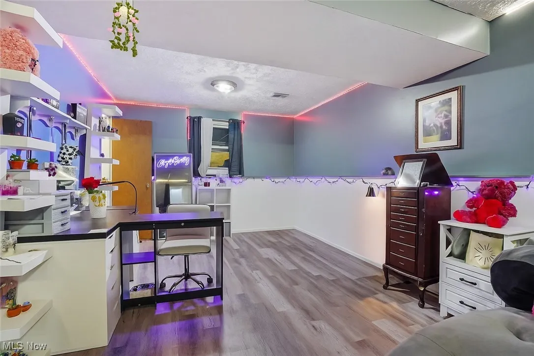 Office space featuring dark wood finished floors and a textured ceiling