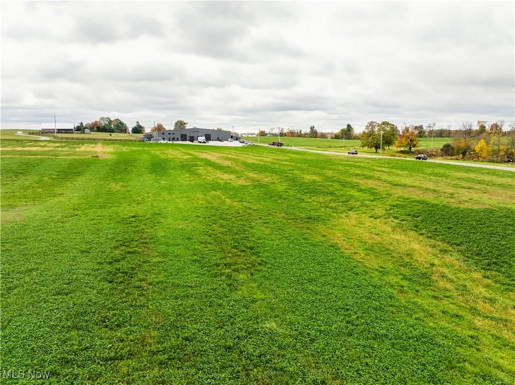 Surrounding community featuring a lawn and a rural view