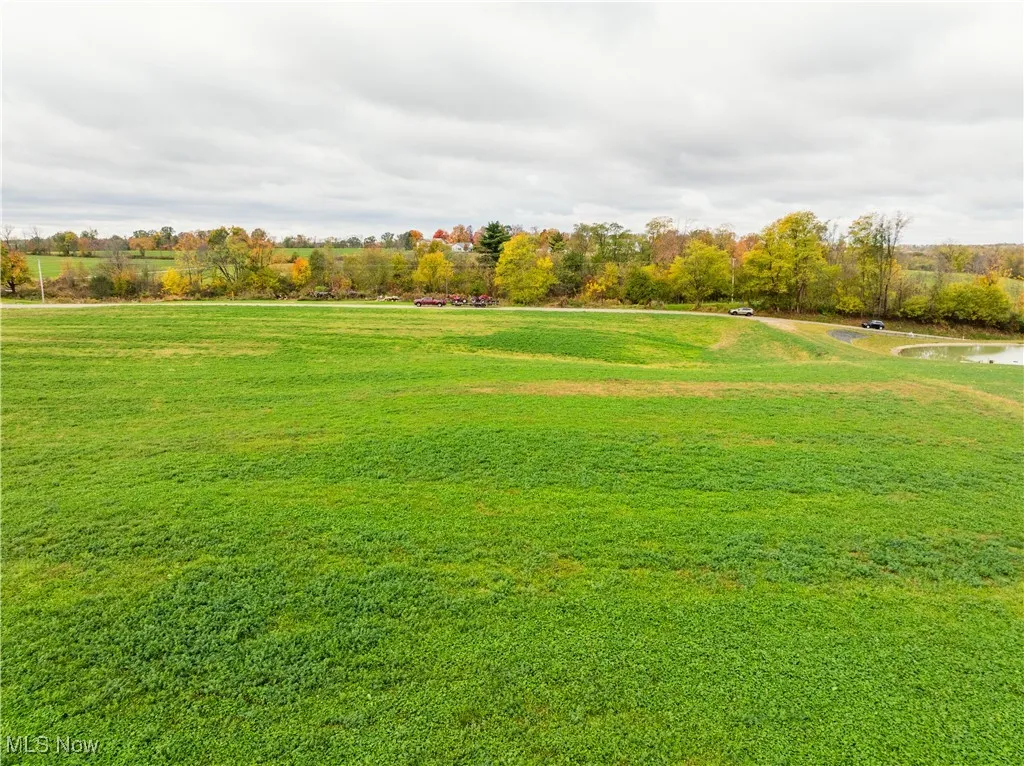 View of property's community with a lawn