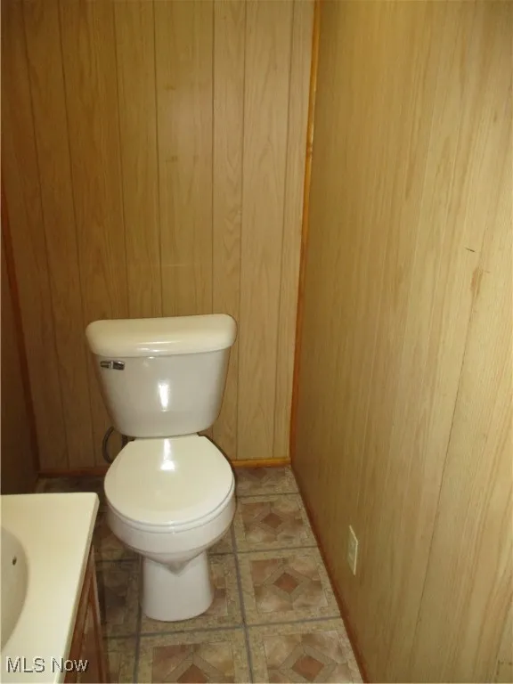 Small lower level 1/2 Bathroom with vanity and toilet