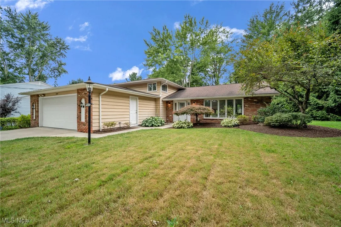 View of front of house featuring a garage and a front yard