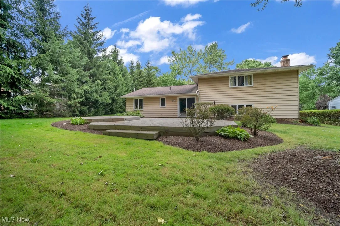 Rear view of property featuring a yard