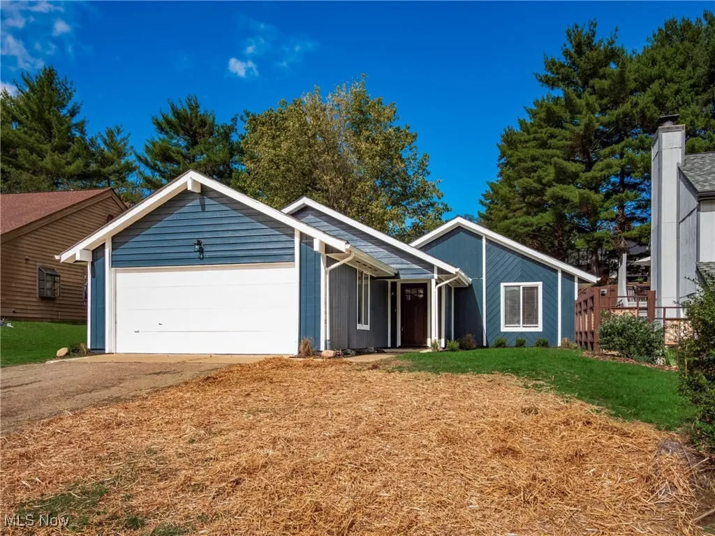 View of front of home featuring driveway and an attached garage