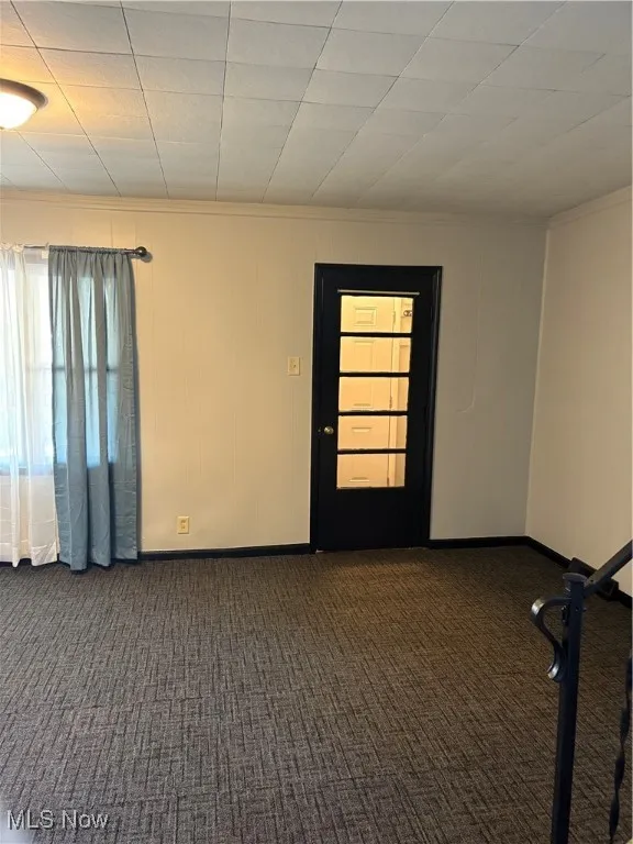 Living room with door to front entry way