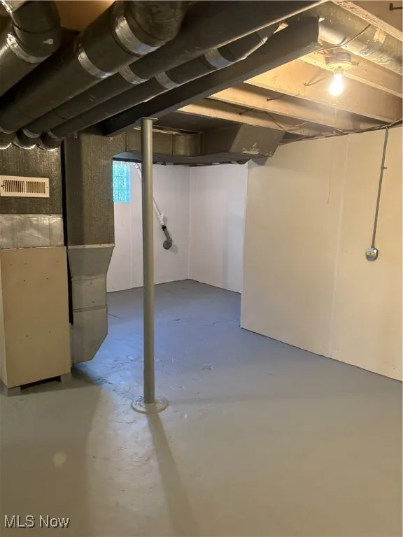 Unfinished below grade area with heating unit