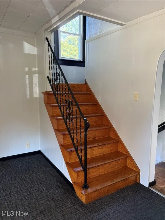 Wood Stairs to second floor, black iron hand railing