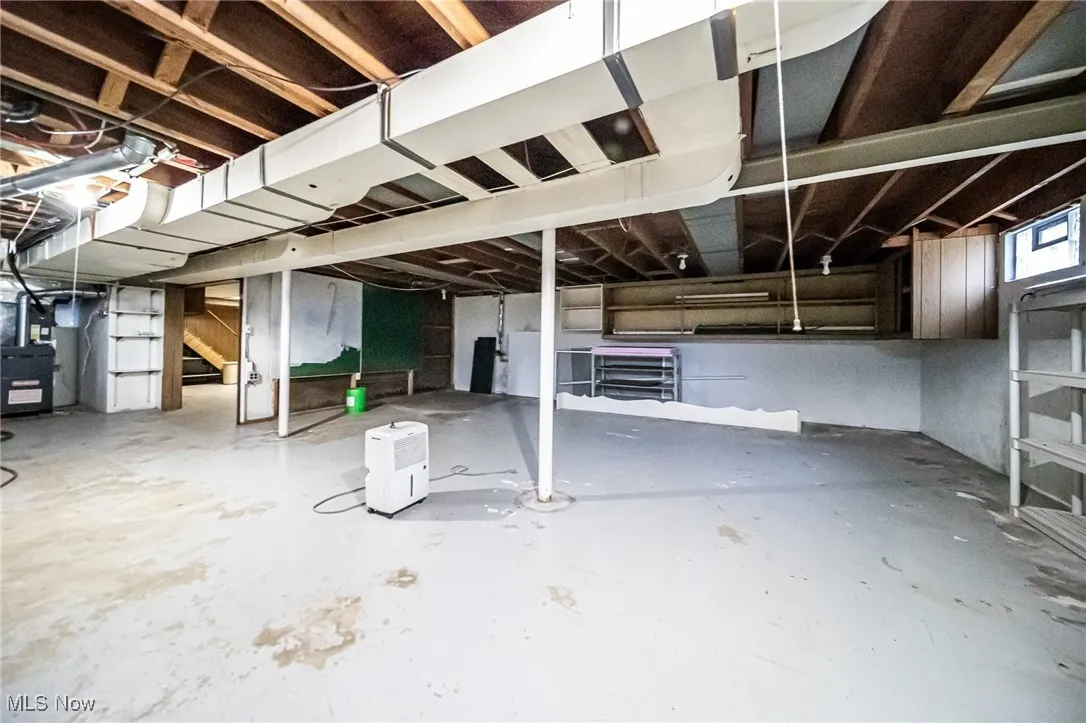 Basement with stairway and heating unit