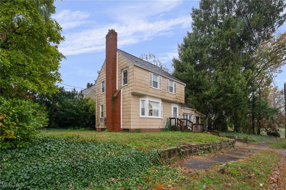 View of side of property with a chimney