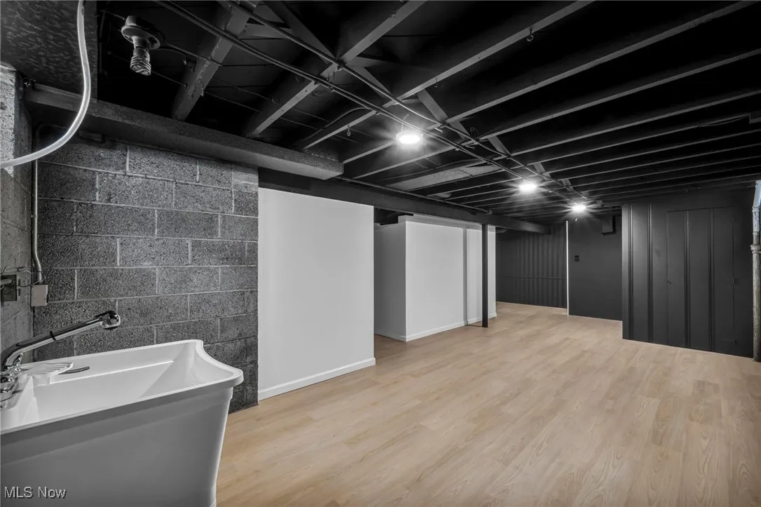 Finished below grade area featuring light wood-style flooring