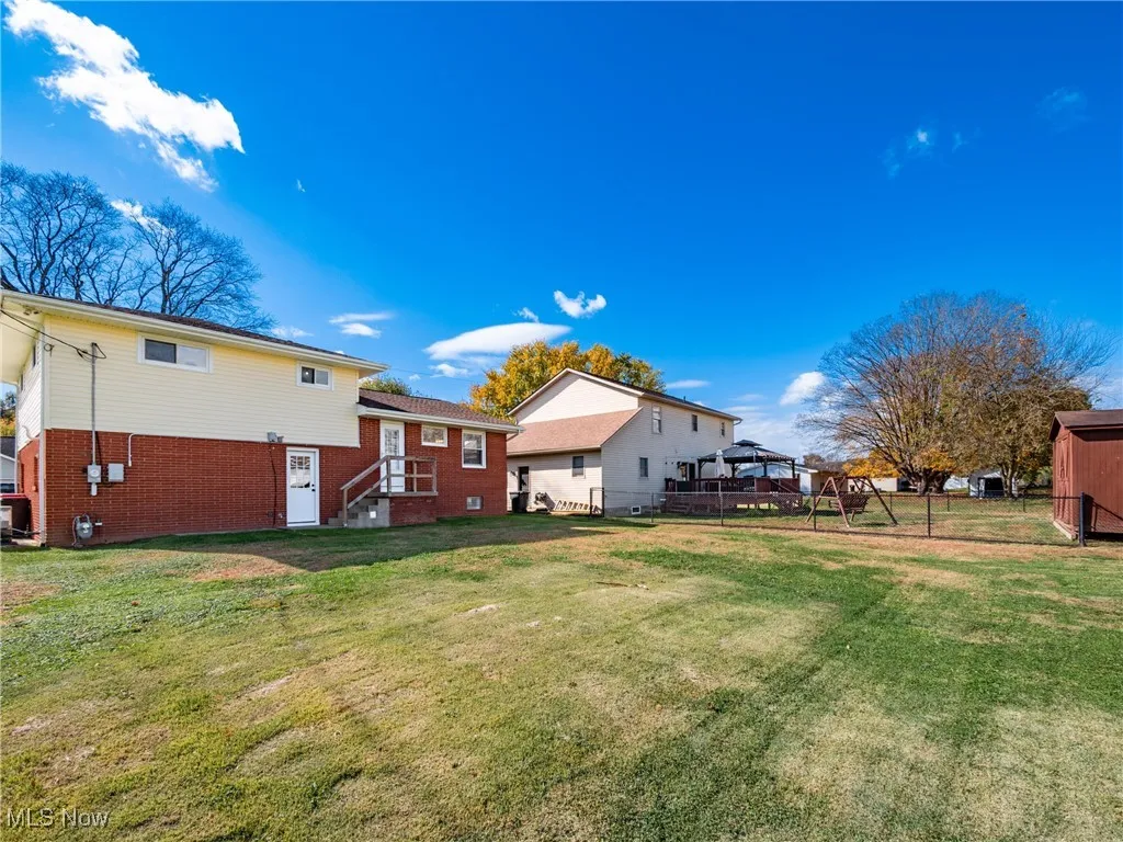 Back of property featuring brick siding