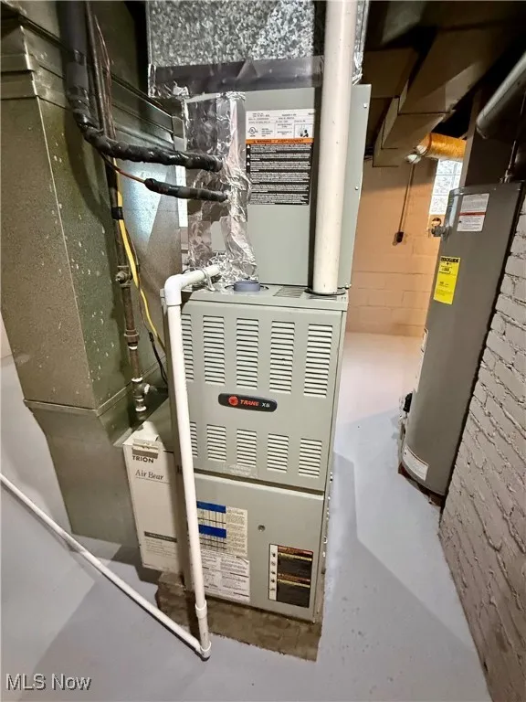 Utility room featuring water heater and Trane furnace