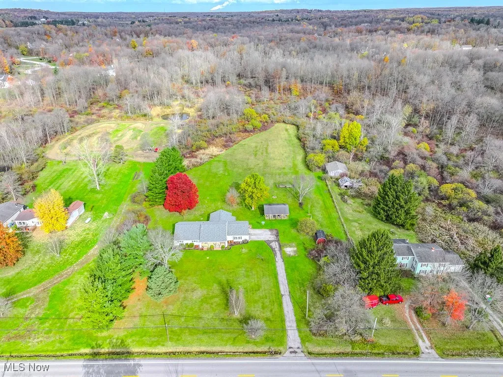 Spacious front and backyards with woods at the rear of the parcel.