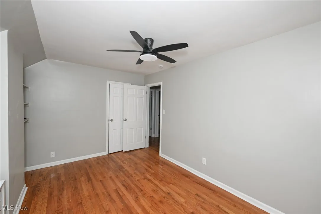 Unfurnished bedroom featuring light wood-style floors, a ceiling fan, and a closet