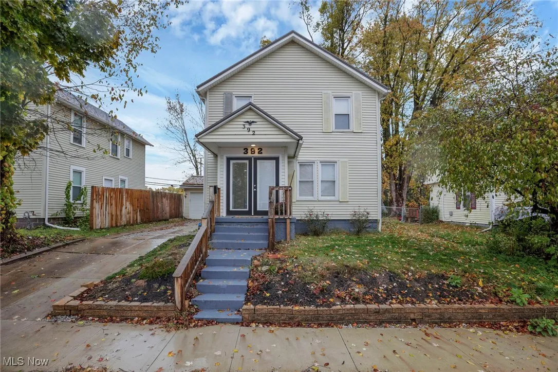 Traditional-style house featuring a garage and driveway