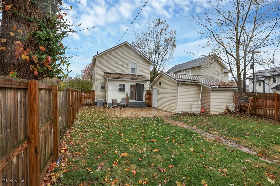 Rear view of property featuring a fenced backyard