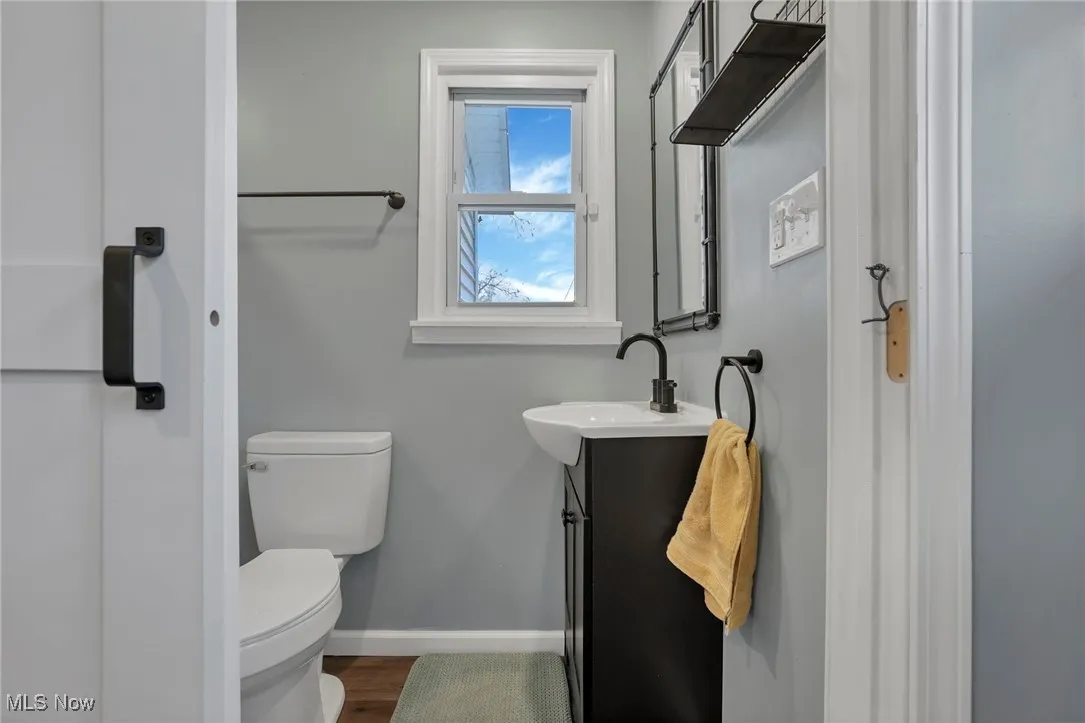 Bathroom featuring vanity and dark wood finished floors