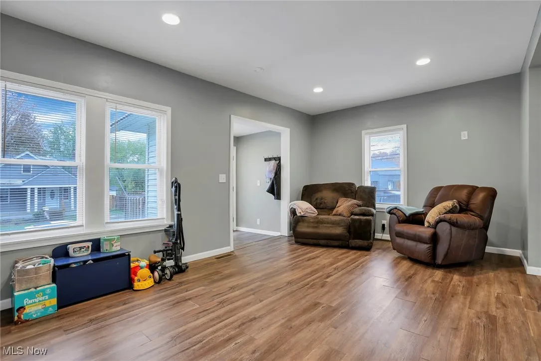 Living area with wood finished floors and recessed lighting