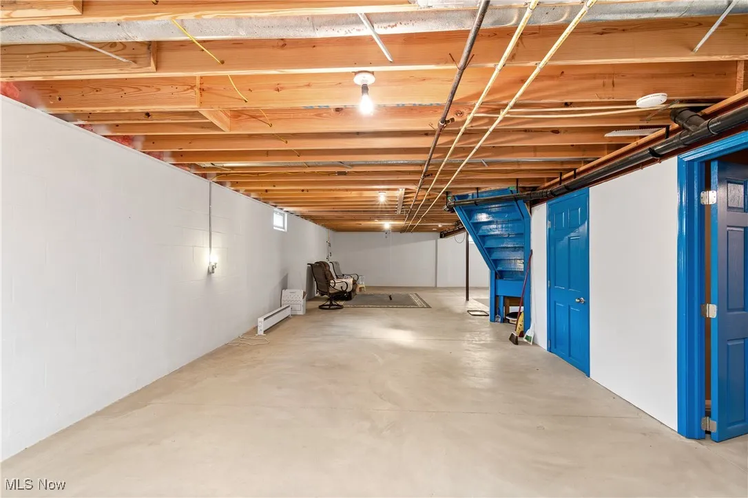 Below grade area featuring a baseboard heating unit