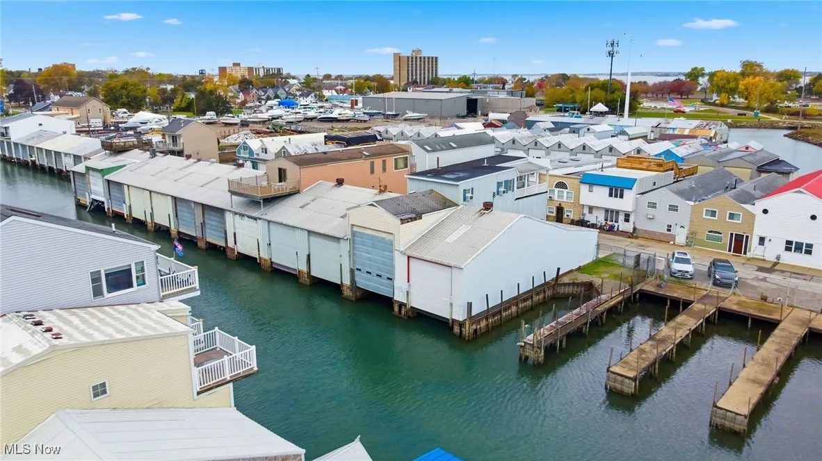 Aerial perspective of suburban area featuring a nearby body of water
