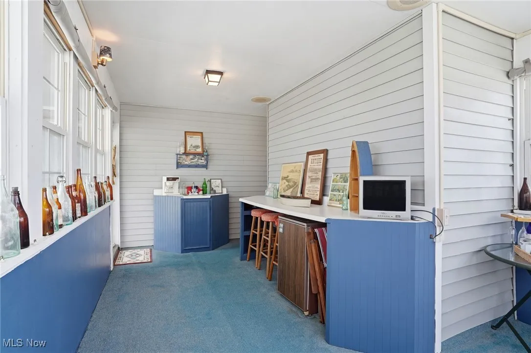 View of patio with a sunroom
