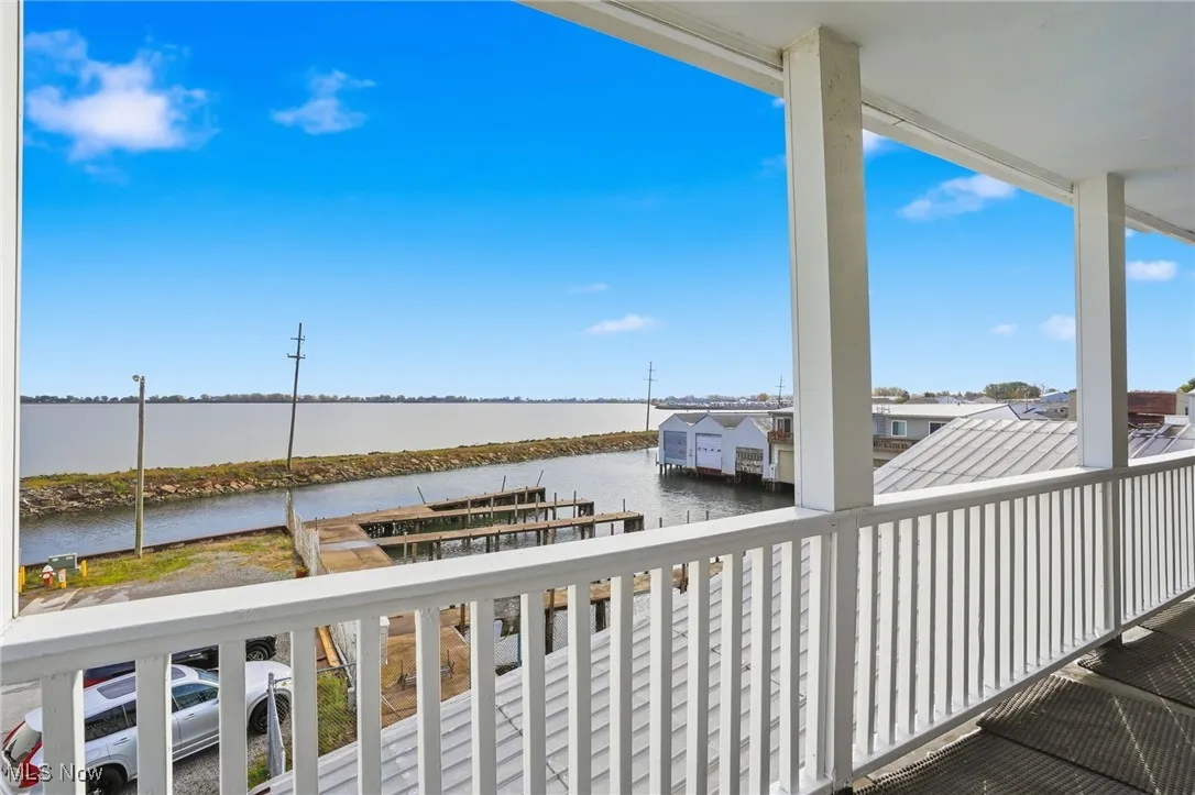 Balcony with a water view, a boat dock, and boat lift