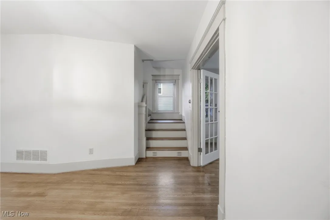 Stairway featuring wood finished floors and baseboards