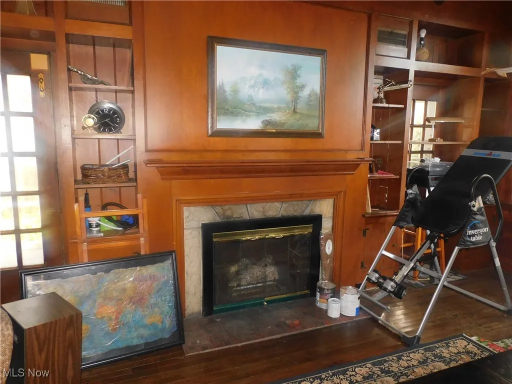 family room fireplace Detailed view of a fireplace, built in shelves, and wood finished floors