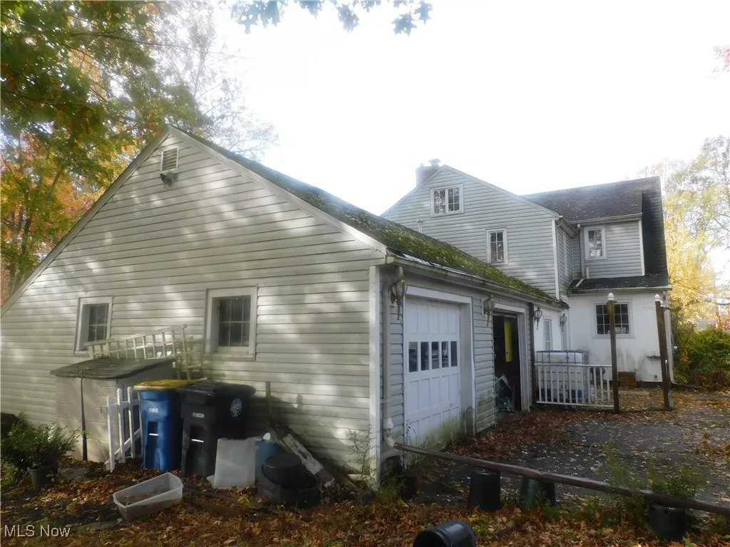 Rear view of house featuring an attached garage