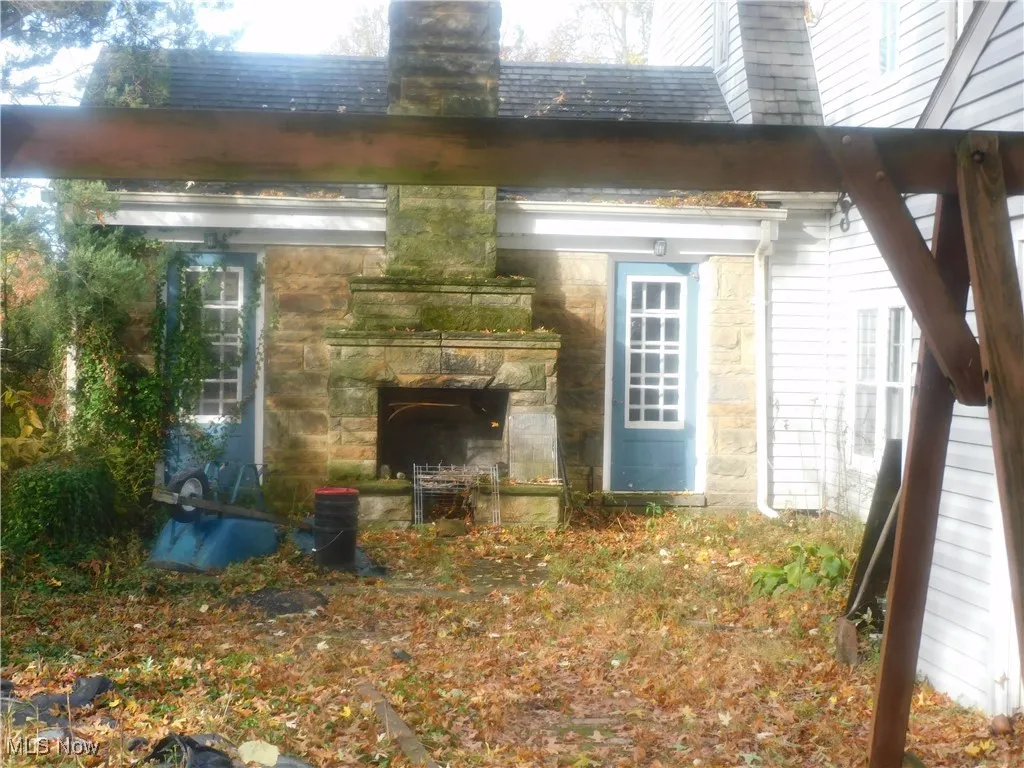 back patio with outdoor fireplace