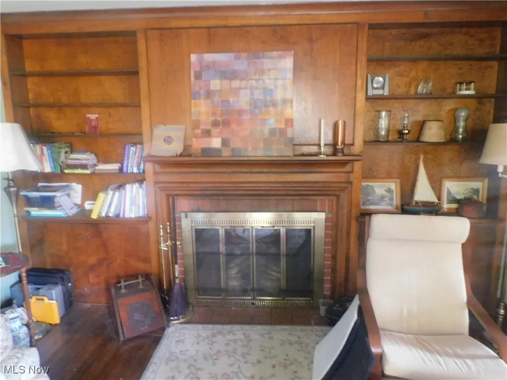 Living room with a glass covered fireplace and wood finished floors