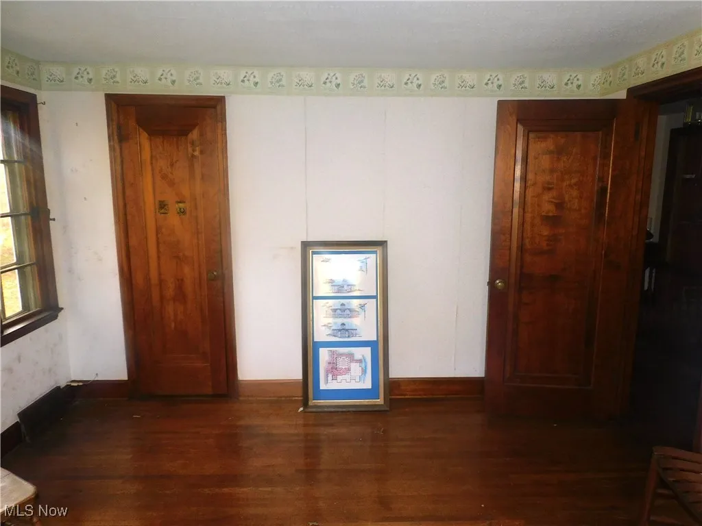 bedroom 3 2nd floor view B  with dark wood-type flooring and wallpapered walls