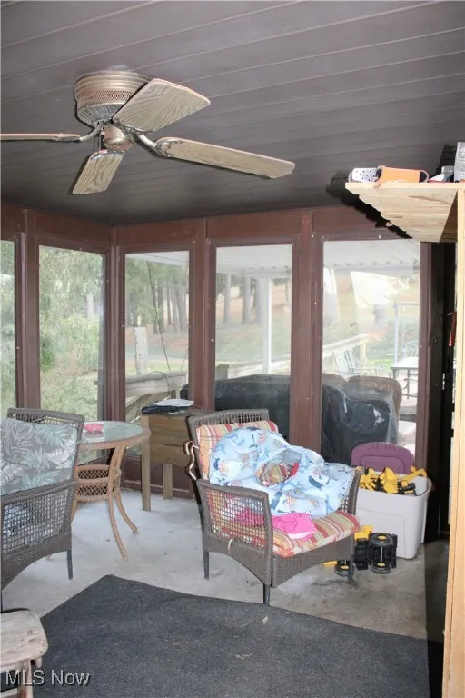 Sunroom featuring ceiling fan and plenty of natural light