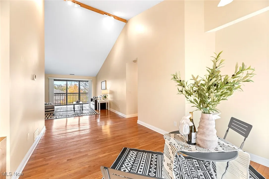 Hall with high vaulted ceiling and light wood-type flooring