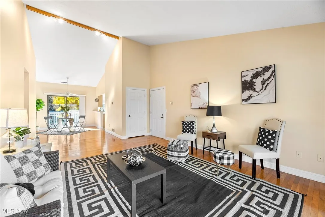 Living area featuring high vaulted ceiling and light wood-style floors
